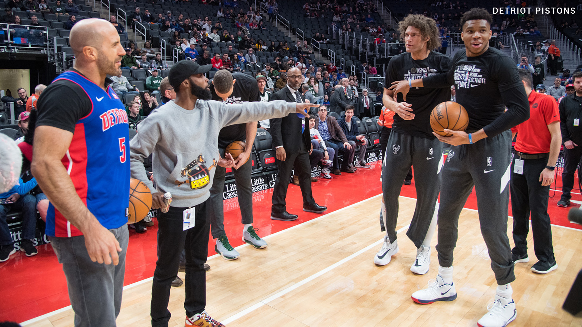 Cesaro confronts Giannis Antetokounmpo and Robin Lopez during Detroit Pistons’ WWE Night