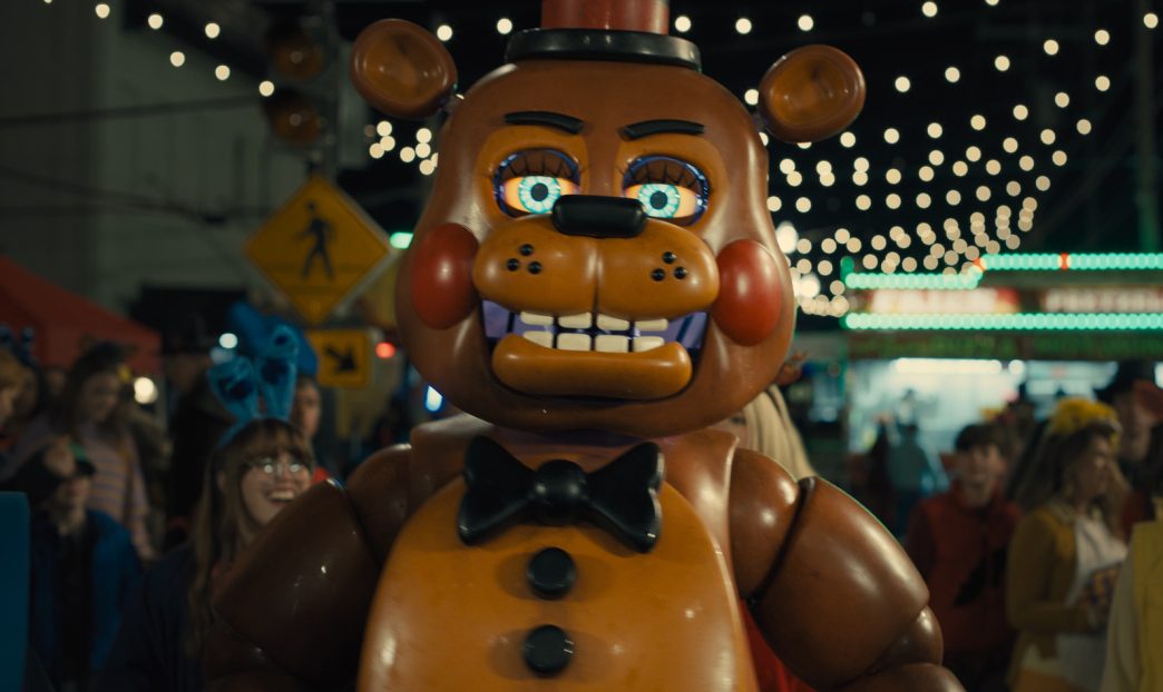 Freddy Fazbear and the animatronics looming in a dark hallway in Five Nights at Freddy’s 2, showcasing the sequel’s improved game-accurate design and atmosphere