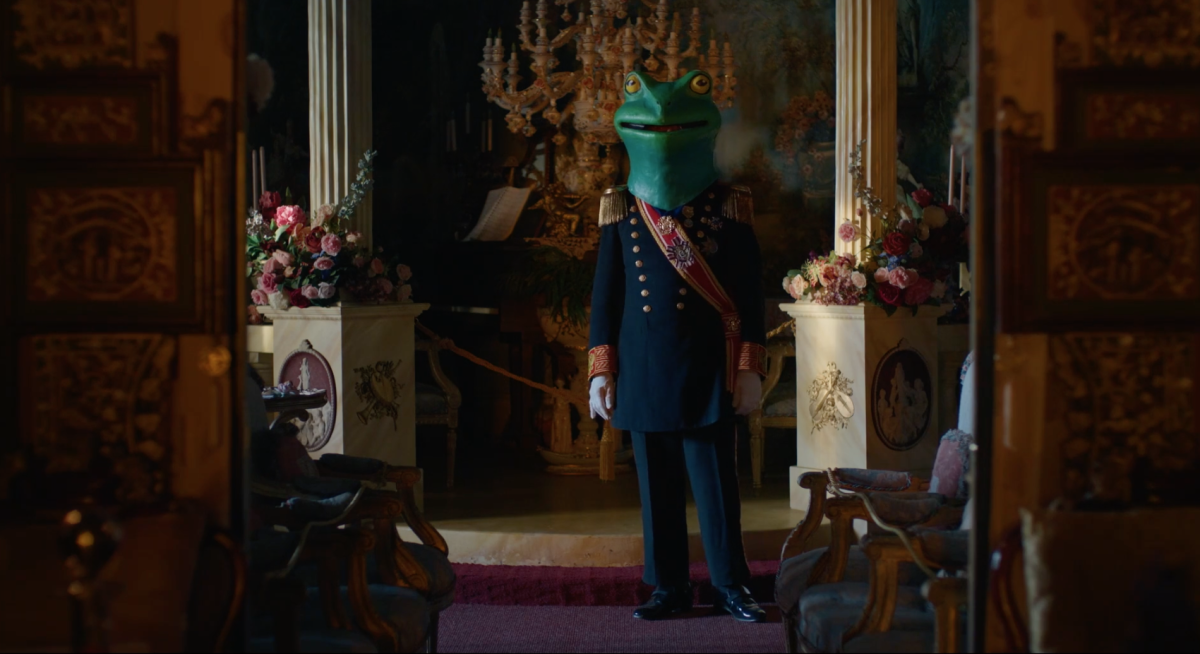 Alan St. George in a mascot frog's head in "Adrianne and The Castle."