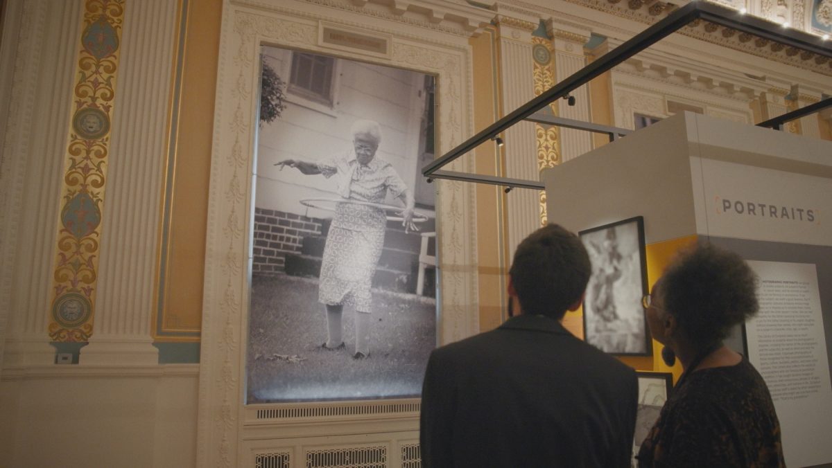 Sharon Farmer and curator in front of her photograph at the Library of Congress.