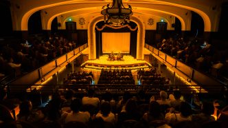 Candlelight concert performance with string musicians surrounded by candles in an intimate venue
