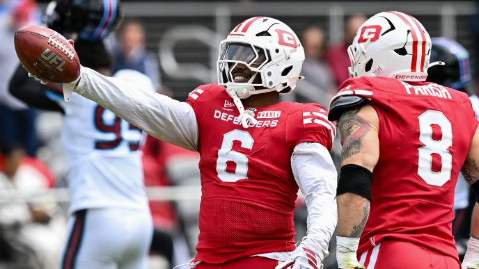 DC Defenders celebrating touchdown at Audi Field with crowd in red and white during UFL game
