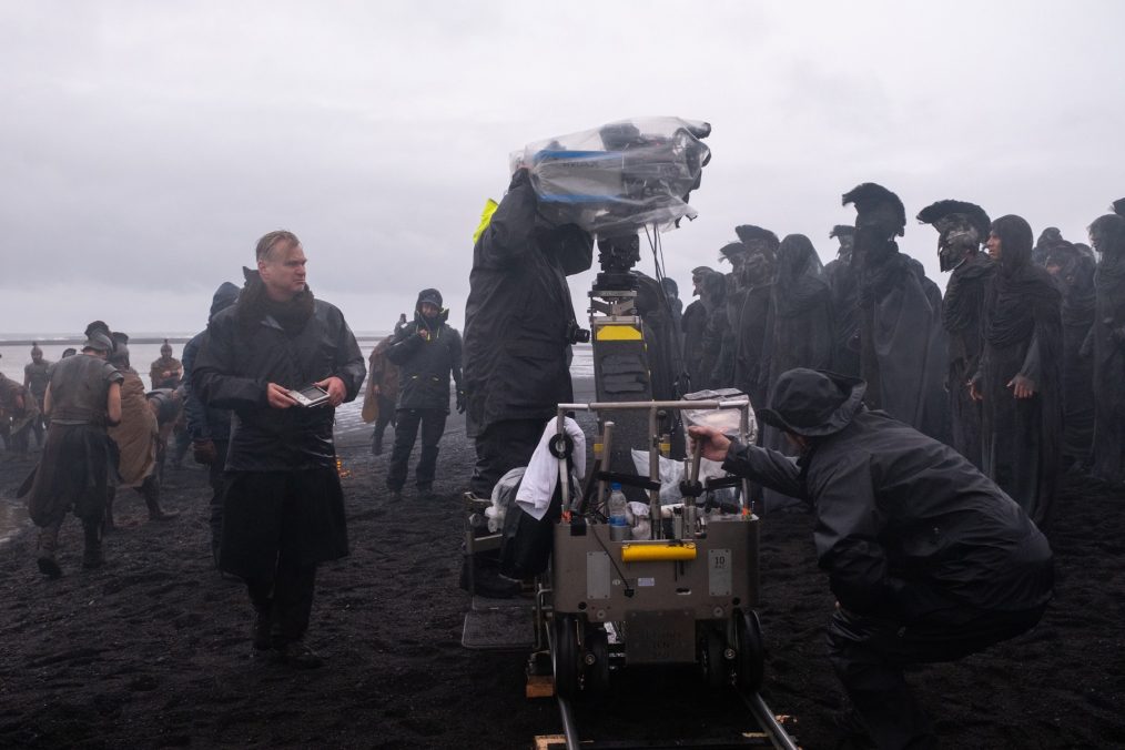 Director Christopher Nolan (frame left) on set of his film THE ODYSSEY, written, produced, and directed by Christopher Nolan. Melinda Sue Gordon/Universal Pictures